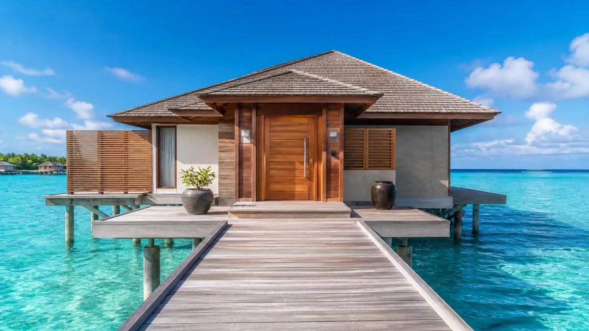 Overwater resort villa entrance with moisture-resistant timber-finish door and stainless hardware