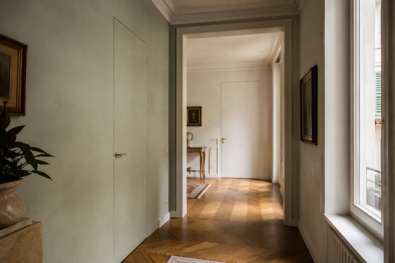 Tall white primed flush interior doors in a classic Italian apartment hallway