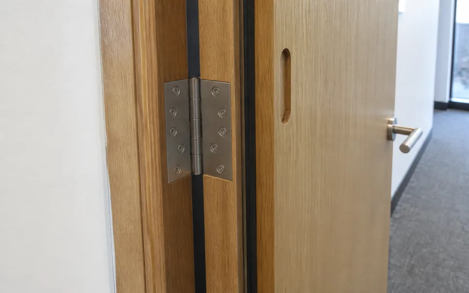 Acoustic timber office door frame with seal, hinge and hardware preparation detail