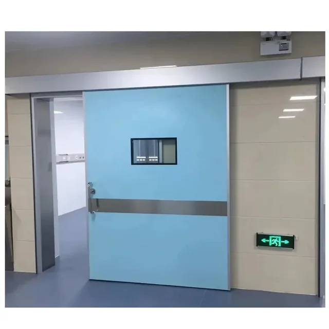 Blue hospital sliding door with vision panel in a healthcare corridor