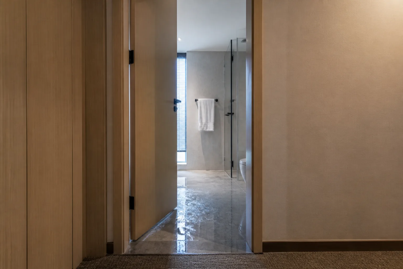 Waterproof WPC door installed at a hotel bathroom entrance