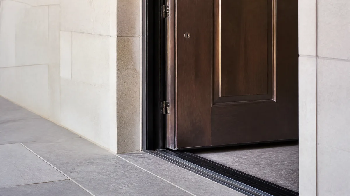 Entry door set showing jamb depth, threshold and finished wall coordination at a project opening